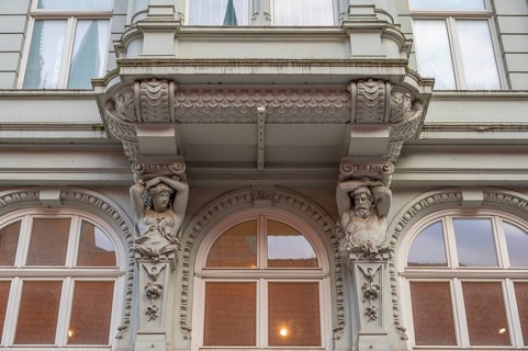 Caryatids at the bottom of a bay window in a historic residential building, 19th century, Hanseatic