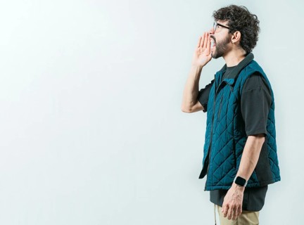 Male person shouting an announcement isolated. Casual young man in glasses shouting a promotion