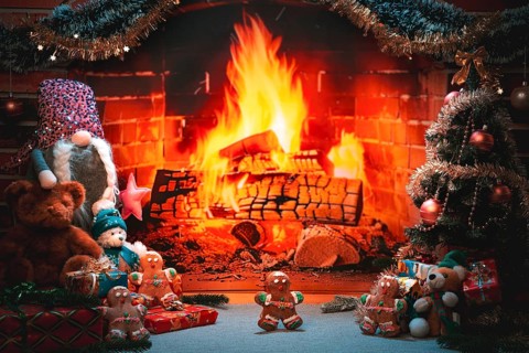Fireplace surrounded by Christmas decorations, gingerbread and gifts