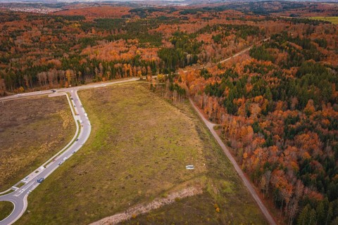 Wide fields and autumn forests criss-crossed by paths and roads, new Lindenrain industrial park,