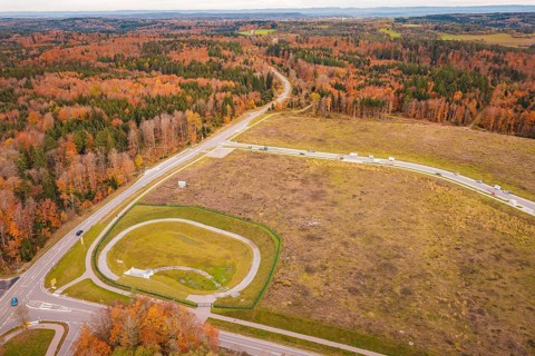 Extensive autumn landscape with crossroads surrounded by forests, new Lindenrain industrial park,