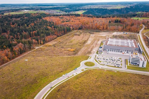 Industrial area with modern building on the edge of the forest and autumn landscape, new Lindenrain