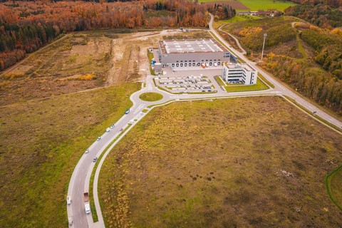 Industrial plant with surrounding roads and parking areas in an autumn landscape, new Lindenrain