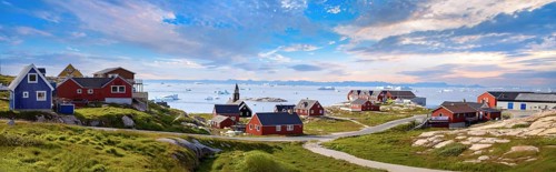 Typical architecture of Greenland Ilulissat with colored houses located near fjords and icebergs