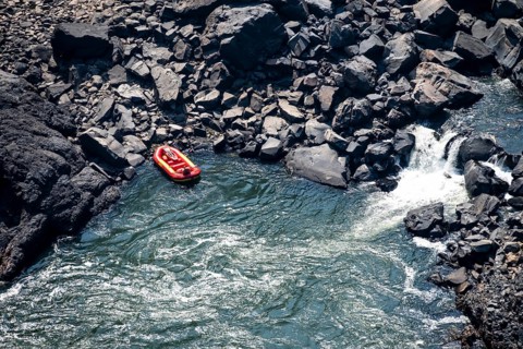 Rafting boat in the river, water plunging into the depths, Victoria Falls, Zambezi, Zimbabwe