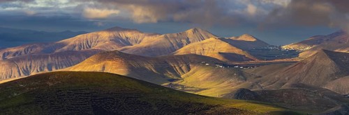 La Geria wine region, behind the volcanic formation Los Ajaches at sunrise, Lanzarote, Canary