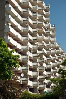 High-rise apartment building with balconies and satellite dishes, satellite town of Chorweiler in