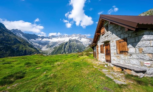 Alpine hut in picturesque mountain landscape with dammastock and damma glacier, Göscheneralp,