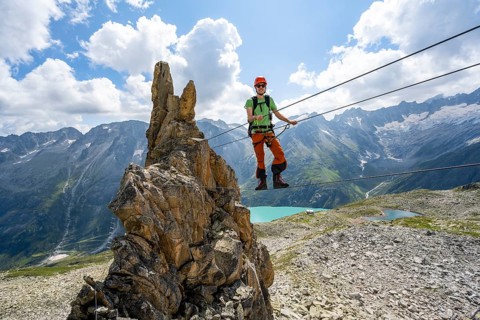 Crocodile rock formation, mountaineer on rope bridge in the Crocodile Mountain Lake via ferrata on