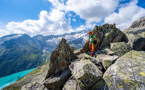 Mountaineers between boulders on the secured via ferrata Crocodile Mountain Lake at