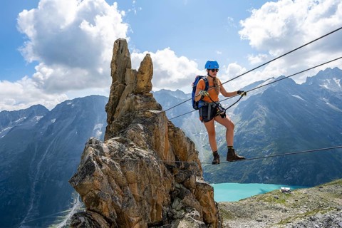 Crocodile rock formation, mountaineer on rope bridge in the Crocodile Mountain Lake via ferrata on