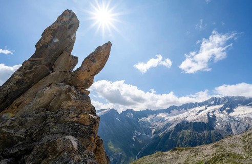 Crocodile rock formation with sun star, view of dam glaciers and dammastock, via ferrata crocodile