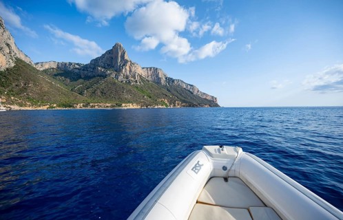 Motorboat trip along the picturesque rocky coast, cliffs and blue sea, Golfo di Orosei, Baunei,