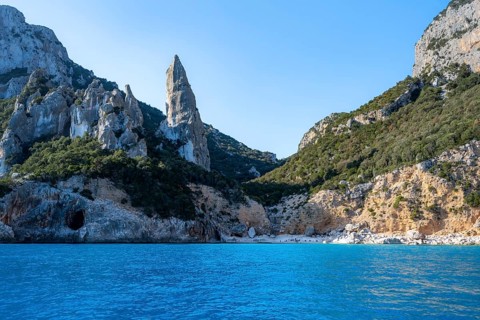 Picturesque rocky coast, cliffs with L'Aguglia pinnacle, blue sea and Cala Goloritzé beach, Golfo