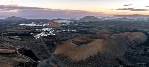 Picturesque volcanic landscape with volcanic craters Montaña de la Tabaiba at sunrise, Parque