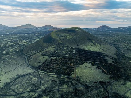 Montaña Negra volcano, picturesque volcanic landscape with volcanic crater at sunrise, Parque