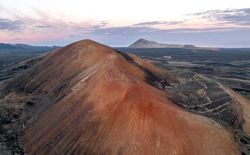 Red volcano Montaña Corujo, picturesque volcanic landscape with volcanic craters at sunrise, Parque
