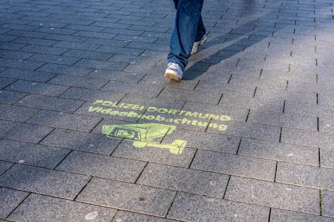 Note, sprayed on the ground that the police have set up comprehensive video surveillance in the
