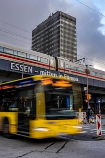 Ruhrbahn bus leaves the bus station at Essen main station, ICE train on track 1 in the train