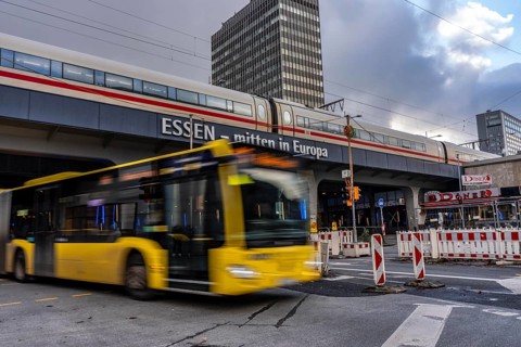 Ruhrbahn bus leaves the bus station at Essen main station, ICE train on track 1 in the train