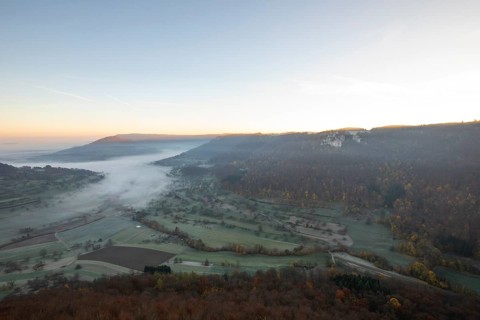 Sunrise with fog in the Neidlinger Valley with a view of the Reussenstein castle ruins. Swabian