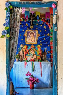 Altar inside a simple and rustic house in the interior of Minas Gerais, Brazil with objects, saints