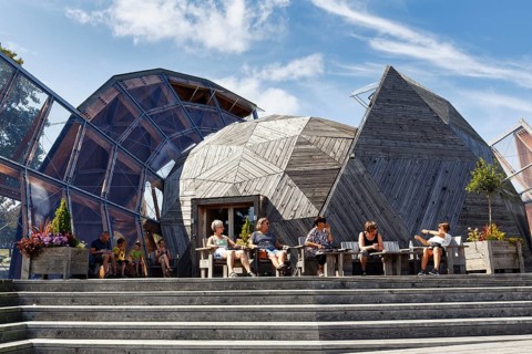 Modern roof structure made of wood and glass, modern architecture, visitors in front of Domen