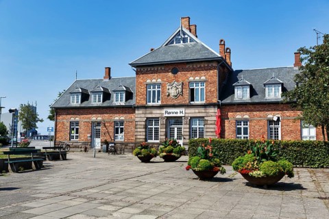 Rønne H, former main train station, café and hotel, historic brick architecture with coat of arms,