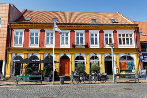 Building with bakery and outdoor seating, square in the old town of Rønne, Bornholm Island, Denmark