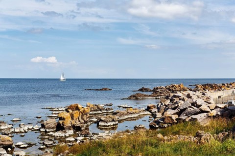 Coastline with granite rocks and sailboat, Hammerknuden, Allinge, Bornholm, Denmark