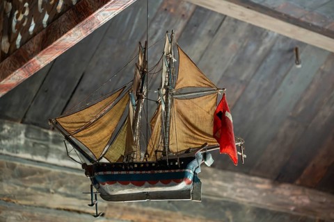 Votive ship in the interior of Garmo Stave Church, Maihaugen open-air museum with houses and