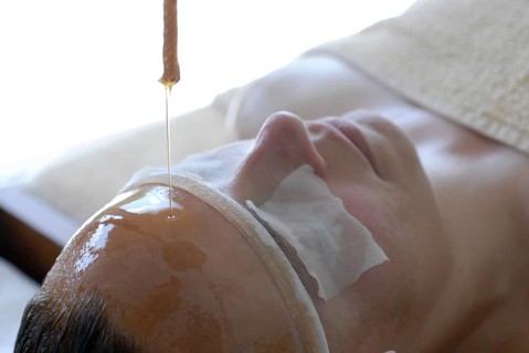 Detail forehead oil glaze or Shirodhara Ayurveda treatment with sesame oil in the spa, Udaipur,