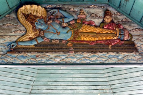 Painted wooden relief, Hindu god Vishnu on the snake Shesha in the primeval sea with wife Lakshmi