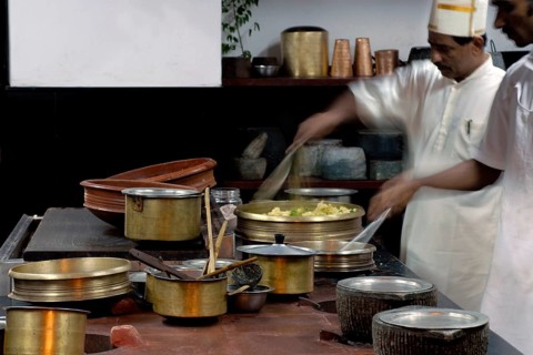 Chefs work in a traditional Tamil kitchen, copper pots and intensive cooking activity, Villa