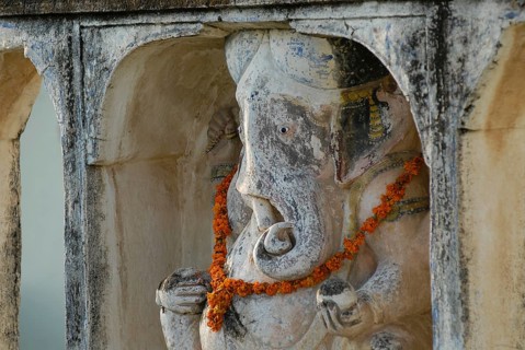 A Ganesha statue decorated with flower garland, Devigarh Palace Hotel, Delwara village near