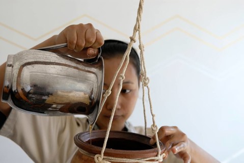 Forehead oil effusion or Shirodhara Ayurveda treatment with sesame oil at the spa, Udaipur,
