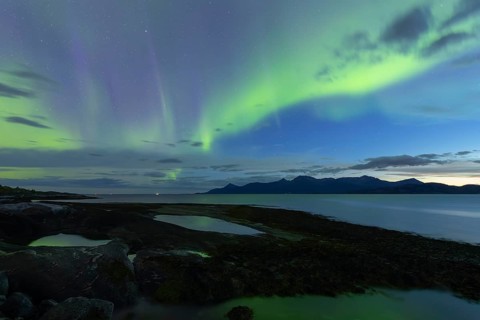 Northern lights at dawn over Sørfolda Fjord near Kjerringøy between Bodø and Sørfold in Norway