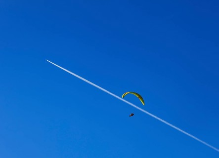 Paragliders with contrails in the blue sky, Osterhorn Group, Salzkammergut, Province of Salzburg,