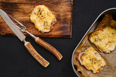 Succulent pork chops are baked to perfection in an air-fryer, topped with melted cheese, and