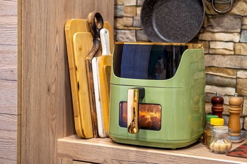 Delicious potato wedges cooking in an air fryer in a cozy kitchen setting