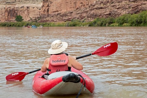Loma, Colorado - A woman paddles an inflatable kayak, part of a river rafting trip on the Colorado