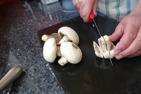 Southern German cuisine, preparing mushrooms, raw mushrooms, cutting, kitchen knife, men's hands,