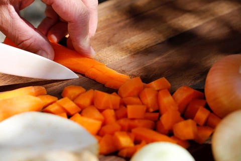 Southern German cuisine, preparing vegetables, cutting raw carrots, celery, onions, vegetarian,