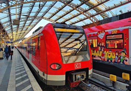 Central Station early in the morning with regional express and S-Bahn with carnival design,
