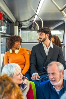 Diverse group of bus passengers traveling together, including a young african american woman