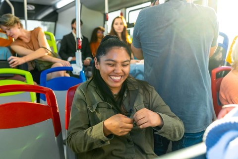 Young woman with closed eyes expressing joy and contentment while traveling on public