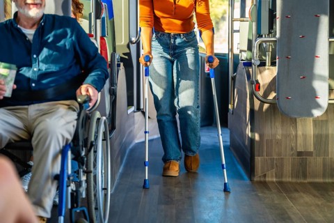 People with disabilities navigating public transportation, with one passenger using a wheelchair