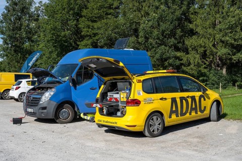 ADAC Strassenwacht vehicle in a parking lot, opened trunk with tools, jump starter for a delivery