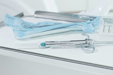 A carpal syringe, reusable, for use in dentistry, for the administration of anesthetic, lies on the