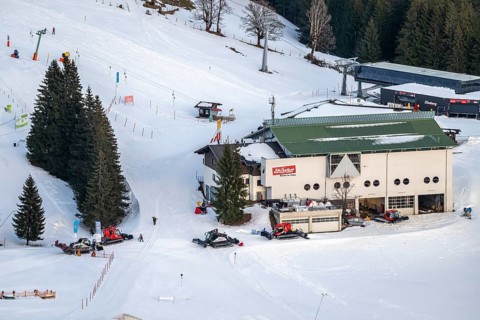 Many snow groomers at the mountain station of the Hochbrixen gondola lift in winter, Skiwelt Wilder